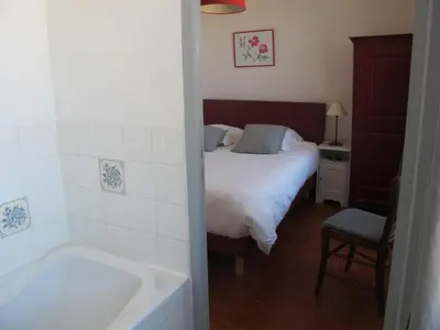 a bedroom with a bed and a bath tub at Le Guintrand in Bédoin