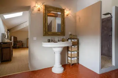 a bathroom with a white sink and a mirror at Luxurious Provencal Village House, Walk to Village Pool in Rustrel