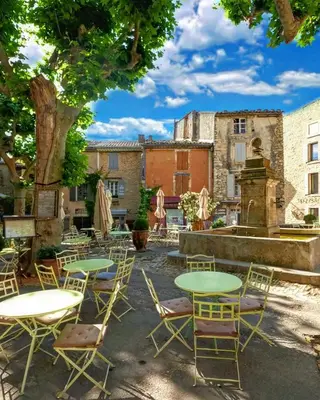 a stone wall with a tree on top of it at Bastidon à Gordes avec piscine in Gordes