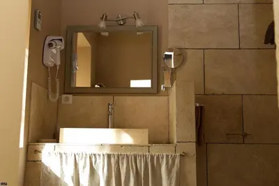 a bathroom with a sink and a mirror at La Bastide de Venelles in Venelles