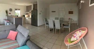 a living room and kitchen with a couch and a table at Villa Zénitude in Cabannes