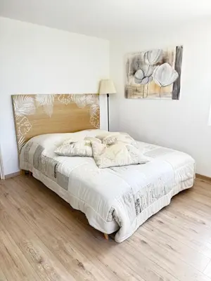 a bedroom with a large bed with white sheets at chez nico in Bédoin