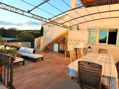 a patio with a pergola and a table at Le Mas de l'Escaillon in Saint-Saturnin-les-Apt