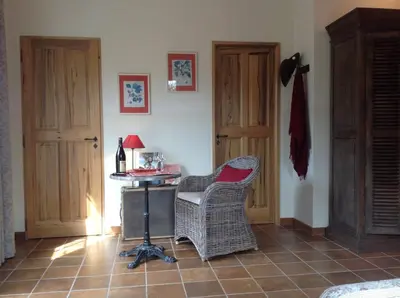 a room with a chair and a desk with a lamp at Le Mas de l'Escaillon in Saint-Saturnin-les-Apt
