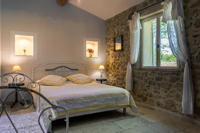 a bedroom with a bed and a window at Gîtes Domaine des Machottes in Grans