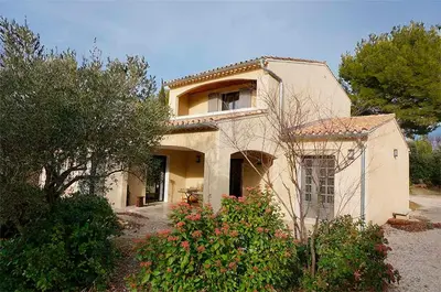 a large white house with trees and bushes at le Gecko en Provence in La Roque-sur-Pernes