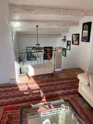 a living room with a couch and a table at Villa des Roses in Roussillon