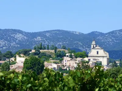 a town on a hill with a church and trees at Chalet by Mont Ventoux with Stunning Views in Bédoin