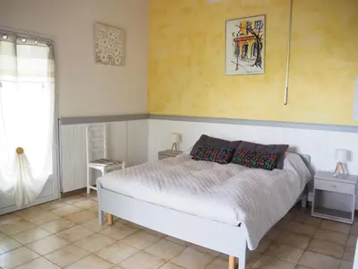 a bedroom with a white bed and a window at Chalet by Mont Ventoux with Stunning Views in Bédoin