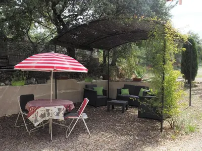 a patio with an umbrella and a table and chairs at Chalet by Mont Ventoux with Stunning Views in Bédoin