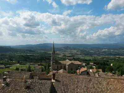 a view of a town with a church tower and roofs at Ménerbes Home with Private Pool in Ménerbes