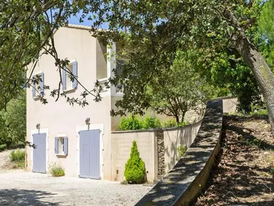 a house with white doors and a fence at Ménerbes Home with Private Pool in Ménerbes
