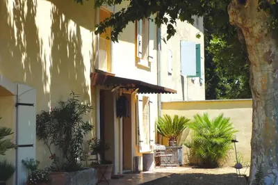 a building with plants on the side of it at Cozy Noves Home with Pool Access in Noves