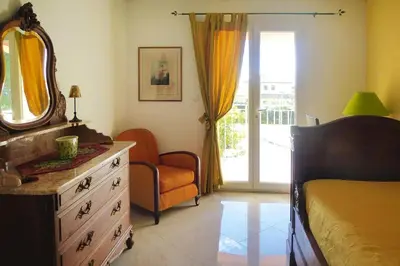a bedroom with a bed and a dresser and a mirror at Premium villa with garden and pool, Lambesc in Lambesc