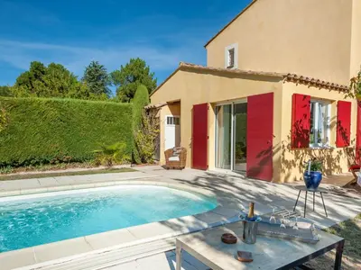 a villa with a swimming pool in front of a house at Holiday Home Mas de L'Oulivier by Interhome in Roussillon