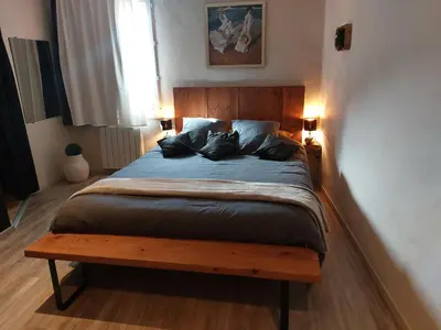 a bedroom with a bed and a table in it at Côté Terrasse in Apt