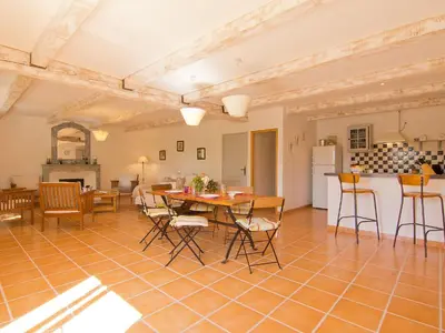 a kitchen and dining room with a table and chairs at Holiday Home L'Olivier by Interhome in Lagnes