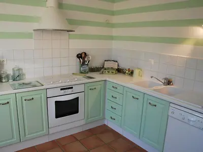 a kitchen with green cabinets and a sink at Holiday Home Clos Saint Joseph by Interhome in Lagnes