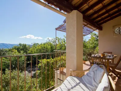 a balcony with a table and a view of the mountains at Holiday Home Les Cairnes by Interhome in Viens