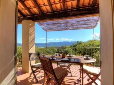 a patio with a table and chairs on a deck at Holiday Home Les Cairnes by Interhome in Viens