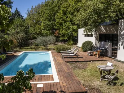 a backyard with a swimming pool and a wooden deck at Holiday Home Villa Isabelle by Interhome in Gondonnets