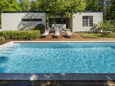 a swimming pool in the backyard of a house at Holiday Home Villa Isabelle by Interhome in Gondonnets