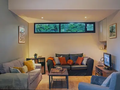 a living room with two couches and a tv at Holiday Home Villa Isabelle by Interhome in Gondonnets