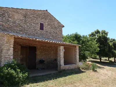 an external view of a stone house with trees at Holiday Home Les Geais by Interhome in Saint-Saturnin-les-Apt