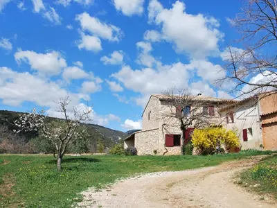 an old stone building in a field with a dirt road at Holiday Home Les Geais by Interhome in Saint-Saturnin-les-Apt