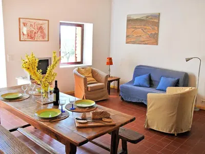 a living room with a table and a couch at Holiday Home Les Geais by Interhome in Saint-Saturnin-les-Apt