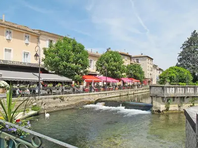a bridge over a river in a city at Apartment Haider by Interhome in Caumont-sur-Durance