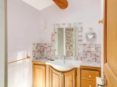 a bathroom with a sink and a mirror at Holiday Home Les Cotes by Interhome in Saint-Martin-de-Castillon