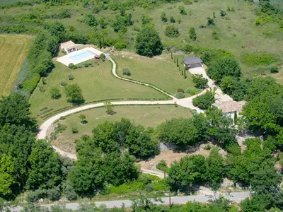 an aerial view of a house with a swimming pool on a hill at Holiday Home Les Cotes by Interhome in Saint-Martin-de-Castillon
