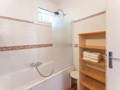 a bathroom with a shower and a tub and a sink at Holiday Home Les Ecureuils by Interhome in Saint-Pantaléon