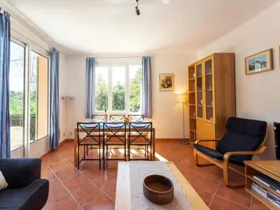 a living room with a table and chairs at Holiday Home Les Ecureuils by Interhome in Saint-Pantaléon
