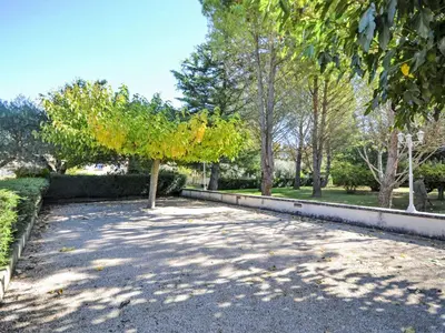 a tree in the middle of a gravel road at Holiday Home de la Roque by Interhome in Althen-des-Paluds