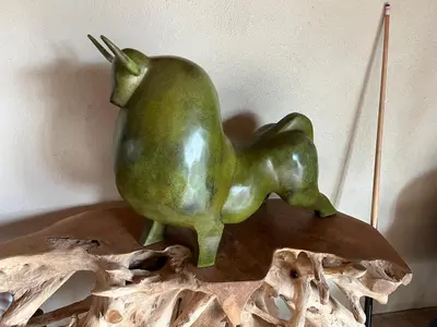 a green statue of a pear on a table at Mas de Nonin St Rémy de Provence in Noves