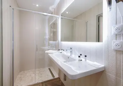 a white bathroom with a sink and a shower at Le Jas de Gordes in Gordes