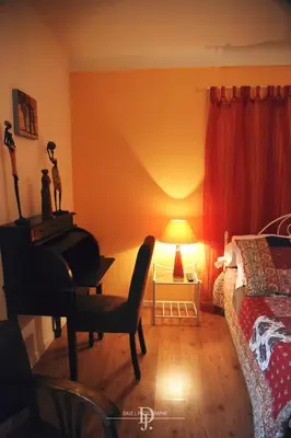 a bedroom with a bed and a desk and a chair at Mas de la Sauline in La Roque-dʼAnthéron