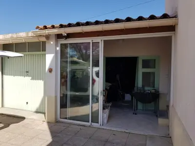 an open sliding glass door to a patio at Location maison Monteux in Monteux