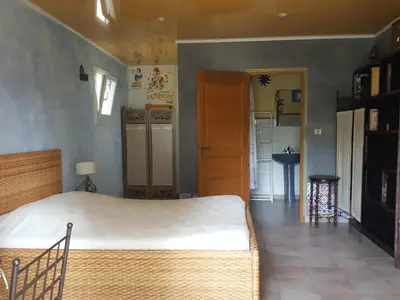 a bedroom with a large bed in a room at L'OLIVERAIE EN PROVENCE in Lambesc