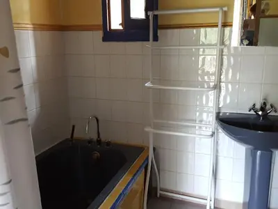 a bathroom with a bath tub and a sink at L'OLIVERAIE EN PROVENCE in Lambesc
