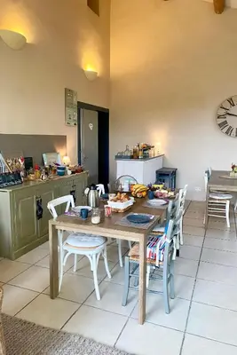 a kitchen with a wooden table and chairs in a kitchen at Mas Les Fleurs d’Hilaire in Monteux
