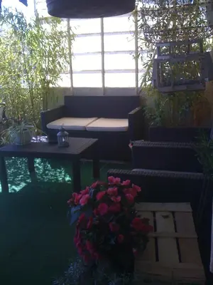 a patio with a bench and a table and flowers at L'Auberge Espagnole - Bed & Breakfast in Apt