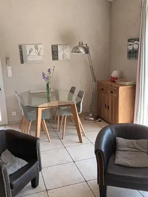 a dining room with a glass table and chairs at Le Mas des Genets in Saint-Rémy-de-Provence
