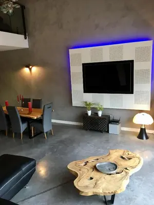 a living room with a table and a large tv at Villa en campagne avec piscine et jacuzzi in Aix-en-Provence