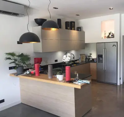 a kitchen with a counter and a refrigerator at Villa en campagne avec piscine et jacuzzi in Aix-en-Provence