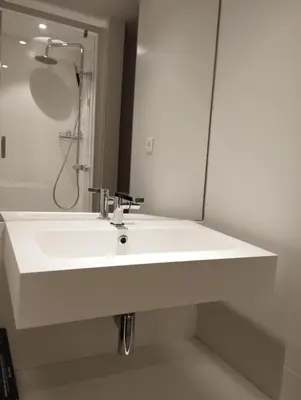 a bathroom with a white sink and a mirror at Maison atypique en Provence chez Brigitte in LʼIsle-sur-la-Sorgue