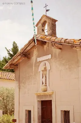 an old church with a bell tower and a cross at Domaine de Blanche Fleur in Châteauneuf-de-Gadagne