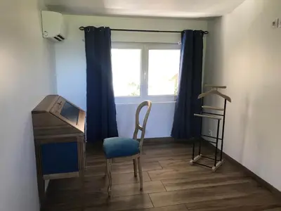 a room with a desk and a chair and a window at Maison 4 étoiles et Studio 3 étoiles indépendants avec piscine in LʼIsle-sur-la-Sorgue